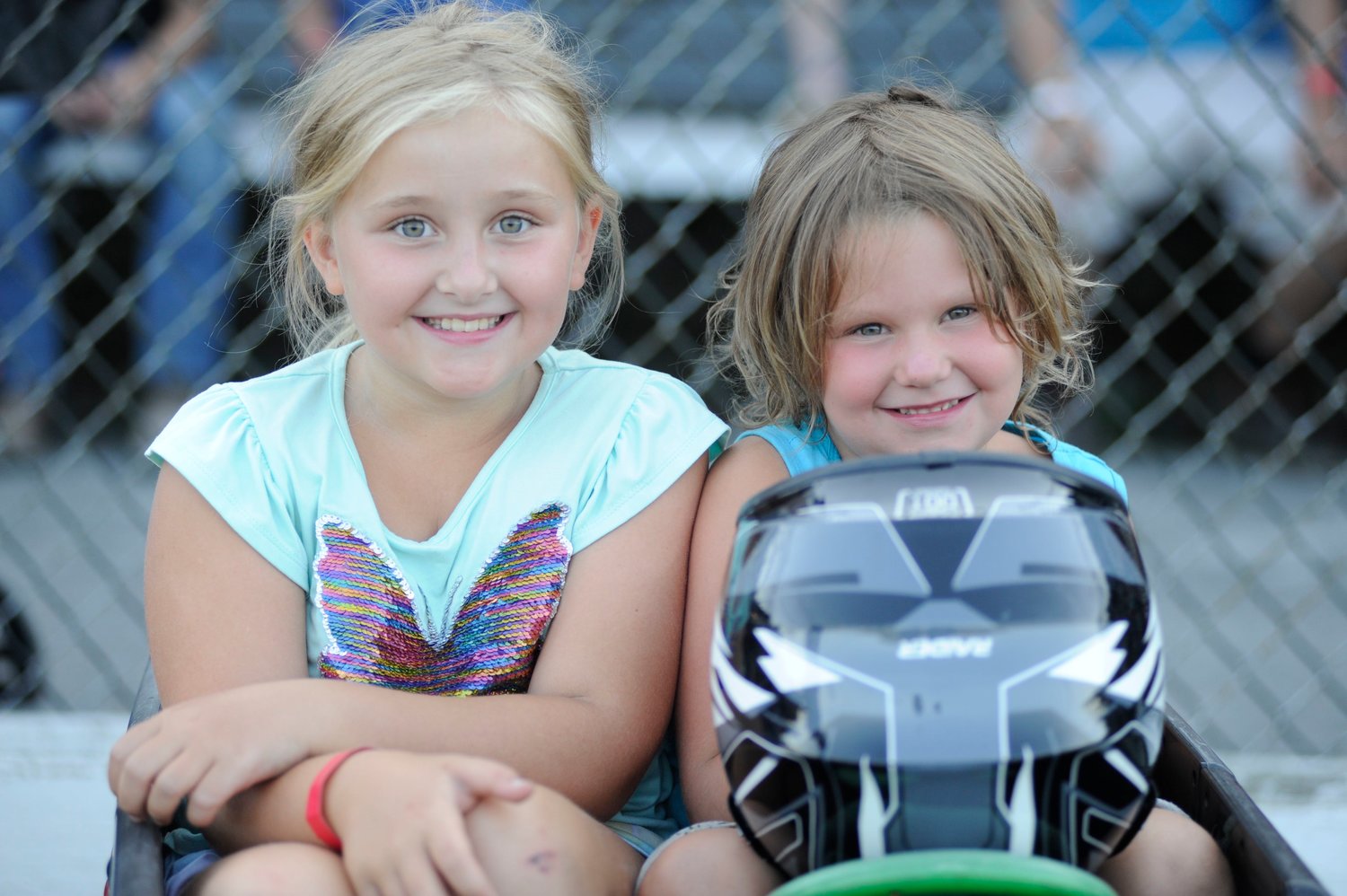 Future demo derby champs? Mackenzy Hansen, 9, and her 5-year-old sister Piper prepare to battle other youngsters in a scaled-down, kids-only version of a “demo derby.” ..